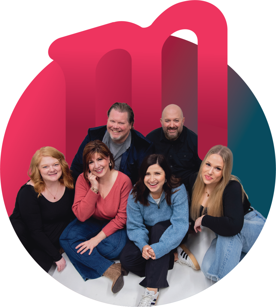 Moxie Creative team smiling and collaborating in a discussion in Saint Cloud, MN