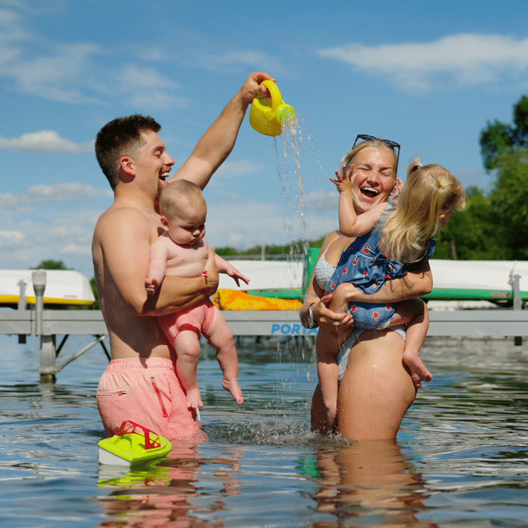 Family playing in the lake beside a Porta-Dock dock, from a brand video shoot directed by Moxie Creative